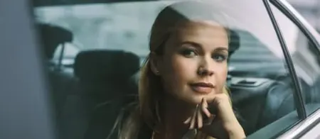 Passenger enjoying a comfortable ride in a vehicle.
